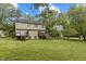 A view of the home's backyard showcasing green space, trees, and multiple wooden decks at 204 Allen St # A/B, Creedmoor, NC 27522