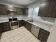 Modern kitchen features stainless steel appliances, granite countertops, and dark wood cabinetry at 204 Allen St # A/B, Creedmoor, NC 27522