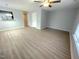 Bright living room boasts sleek wood floors, neutral walls, and a modern ceiling fan at 204 Allen St # A/B, Creedmoor, NC 27522