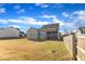 A spacious backyard featuring a covered porch and wood fence, offering privacy and space at 208 Tarkenton Ct, Clayton, NC 27527