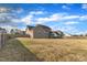 Spacious backyard with a large lawn and fenced perimeter, perfect for outdoor activities at 208 Tarkenton Ct, Clayton, NC 27527