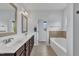 Bathroom showcasing a double sink vanity, tiled floor, and a separate tub and shower at 208 Tarkenton Ct, Clayton, NC 27527