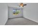 A well lit room with a neutral color palette and a large window at 208 Tarkenton Ct, Clayton, NC 27527