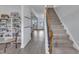 Inviting foyer featuring a staircase and shelving, leading to the main living area at 208 Tarkenton Ct, Clayton, NC 27527
