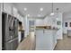 Kitchen view featuring stainless steel appliances, white cabinetry, and hardwood floors at 208 Tarkenton Ct, Clayton, NC 27527