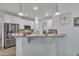 Modern kitchen with granite countertop bar and stainless steel appliances at 208 Tarkenton Ct, Clayton, NC 27527