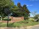 A brick sign for Riverwood Elementary School with mature trees and landscaped lawn at 208 Tarkenton Ct, Clayton, NC 27527