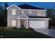 Charming two-story home with gray siding, black roof, attached garage, and well-manicured lawn at 2130 Cherry Creek Rd, Haw River, NC 27258