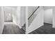 Bright, open foyer with laminate floors, stairs with white risers and a dark wood railing at 2130 Cherry Creek Rd, Haw River, NC 27258