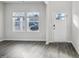 Bright, spacious living room with laminate floors, a large window and a white front door at 2130 Cherry Creek Rd, Haw River, NC 27258