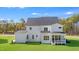 Rear exterior view of a two-story white home with a screened-in porch and green lawn at 216 Meadow Walk Dr, Fuquay Varina, NC 27526