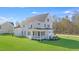 Back exterior of a white two-story home with a screened-in porch and large green lawn at 216 Meadow Walk Dr, Fuquay Varina, NC 27526