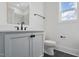 Half bath features slate floors, a white vanity, and black fixtures with a window for natural light at 216 Meadow Walk Dr, Fuquay Varina, NC 27526