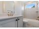 Bathroom featuring neutral color palette, tub, shower, gold fixtures, square tiles, and a window at 216 Meadow Walk Dr, Fuquay Varina, NC 27526