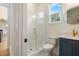 Bathroom features a glass enclosed shower and blue vanity with a gold faucet at 216 Meadow Walk Dr, Fuquay Varina, NC 27526