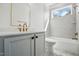 Well lit bathroom with double vanity, neutral tile, and a separate tub and shower at 216 Meadow Walk Dr, Fuquay Varina, NC 27526