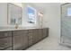 Bathroom boasts a double vanity, marble floors, and a glass enclosed shower with gold hardware at 216 Meadow Walk Dr, Fuquay Varina, NC 27526