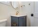 Bathroom featuring a blue vanity with gold hardware, modern fixtures and a toilet at 216 Meadow Walk Dr, Fuquay Varina, NC 27526
