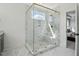Glass enclosed shower features marble tile walls, mosaic flooring, and gold toned hardware at 216 Meadow Walk Dr, Fuquay Varina, NC 27526