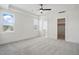 Spacious bedroom with neutral carpet, large windows, and ceiling fan at 216 Meadow Walk Dr, Fuquay Varina, NC 27526