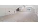 Expansive bonus room with neutral carpet, built-in seating, and natural light at 216 Meadow Walk Dr, Fuquay Varina, NC 27526