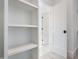 White closet with shelves and open door at 216 Meadow Walk Dr, Fuquay Varina, NC 27526