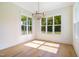 Bright dining room with chandelier and large windows overlooking the backyard at 216 Meadow Walk Dr, Fuquay Varina, NC 27526