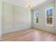 Formal dining room with decorative wall moulding, hardwood floors, and large windows at 216 Meadow Walk Dr, Fuquay Varina, NC 27526