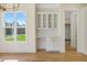 Bright dining room features custom built-in cabinets and shelving in an open-concept floor plan at 216 Meadow Walk Dr, Fuquay Varina, NC 27526