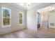 Open concept dining area featuring large windows, hardwood floors, and views to the front entry at 216 Meadow Walk Dr, Fuquay Varina, NC 27526