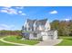 Picturesque white two-story house with a front-facing garage, and a bright blue sky at 216 Meadow Walk Dr, Fuquay Varina, NC 27526