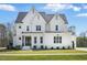 Beautiful two-story white home with well-manicured lawn and inviting front entrance at 216 Meadow Walk Dr, Fuquay Varina, NC 27526