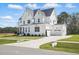 Charming two-story white home with attached garage and long, curved driveway at 216 Meadow Walk Dr, Fuquay Varina, NC 27526