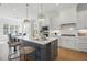 Modern kitchen boasts a large island, white cabinetry, and stainless steel appliances at 216 Meadow Walk Dr, Fuquay Varina, NC 27526
