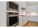 Modern kitchen features stainless steel appliances, white cabinets, and a gas cooktop at 216 Meadow Walk Dr, Fuquay Varina, NC 27526