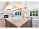 Modern kitchen island features a white countertop, gold faucet, and stylish pendant lighting at 216 Meadow Walk Dr, Fuquay Varina, NC 27526