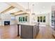 Open concept kitchen and living area features white cabinetry and stainless steel appliances at 216 Meadow Walk Dr, Fuquay Varina, NC 27526