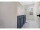 This laundry room features a utility sink, storage cabinets, white walls, shelving and a window with a view at 216 Meadow Walk Dr, Fuquay Varina, NC 27526