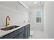 Clean laundry room with utility sink, countertop, and modern cabinets at 216 Meadow Walk Dr, Fuquay Varina, NC 27526