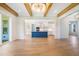 Open living room connecting kitchen and porch, with exposed wooden beams and hardwood floors at 216 Meadow Walk Dr, Fuquay Varina, NC 27526