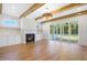 Open concept living room with fireplace, built-in shelves, and sliding doors to the porch at 216 Meadow Walk Dr, Fuquay Varina, NC 27526