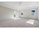 Bright main bedroom with textured accent wall, ceiling fan, and ensuite bathroom at 216 Meadow Walk Dr, Fuquay Varina, NC 27526