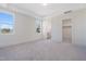 Bright and airy main bedroom with large windows, neutral carpet, tray ceiling and ensuite bathroom at 216 Meadow Walk Dr, Fuquay Varina, NC 27526