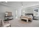A large bedroom featuring stylish decor, a tray ceiling, and carpeted floors at 216 Meadow Walk Dr, Fuquay Varina, NC 27526