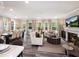 Open concept living room and dining area with fireplace, TV, and plenty of natural light at 231 Shingle Oak Rd, Wake Forest, NC 27587