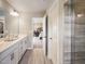 Modern bathroom with double vanity, shower, tile flooring, and access to the bedroom at 233 Shingle Oak Rd, Wake Forest, NC 27587