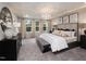 Elegant main bedroom with tray ceiling, plush carpeting, and a sitting area near the window at 233 Shingle Oak Rd, Wake Forest, NC 27587