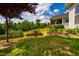 Well-manicured backyard features flower beds, lush lawn, and a black fence, providing a serene outdoor setting at 237 Abercorn Cir, Chapel Hill, NC 27516