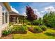 Beautiful yard features landscaped flower beds, a pergola-covered patio, and views of the neighboring home at 237 Abercorn Cir, Chapel Hill, NC 27516