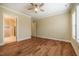 Spacious bedroom with hardwood floors, ceiling fan, and ensuite bathroom access at 237 Abercorn Cir, Chapel Hill, NC 27516